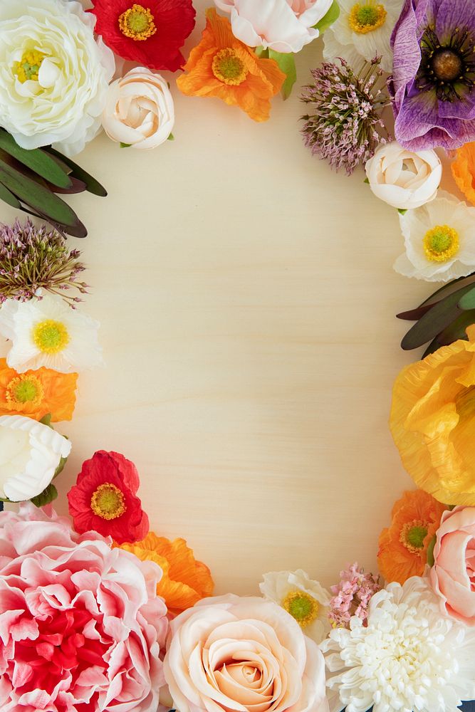 Colorful fresh flowers frame on beige background