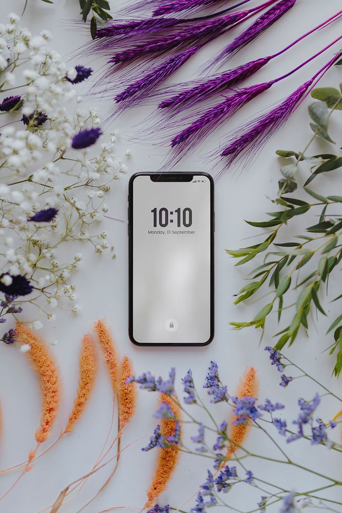 Phone mockup framed with a bunch of dried colorful flowers