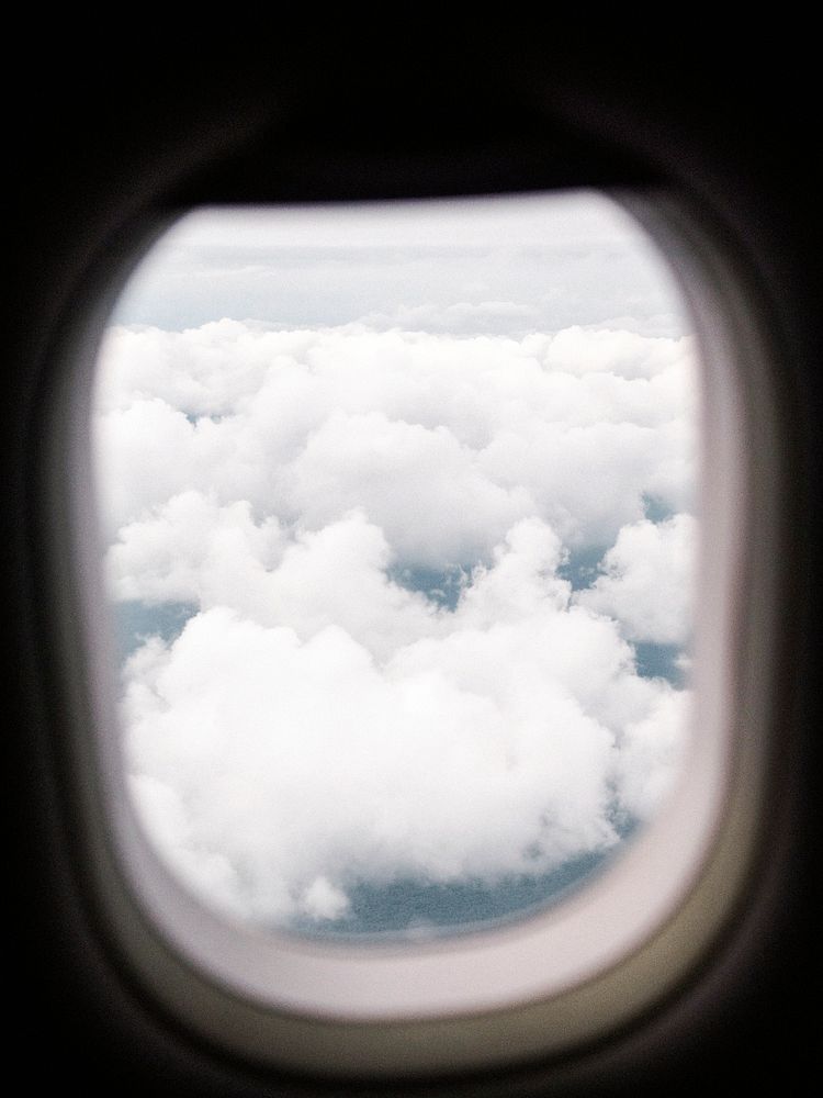 View of a cloudy sky through an airplane window