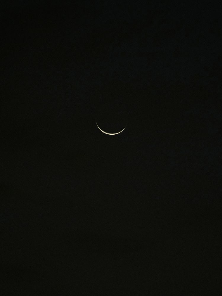 Waning crescent moon on a night sky