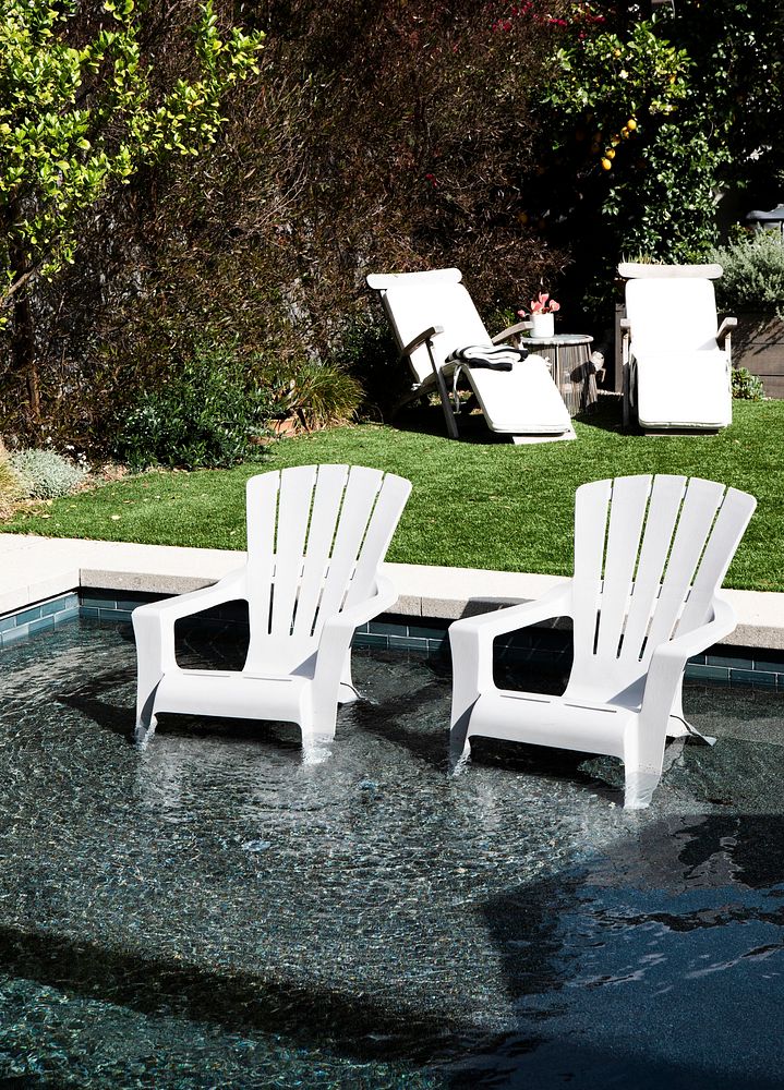 White plastic chairs in a pool