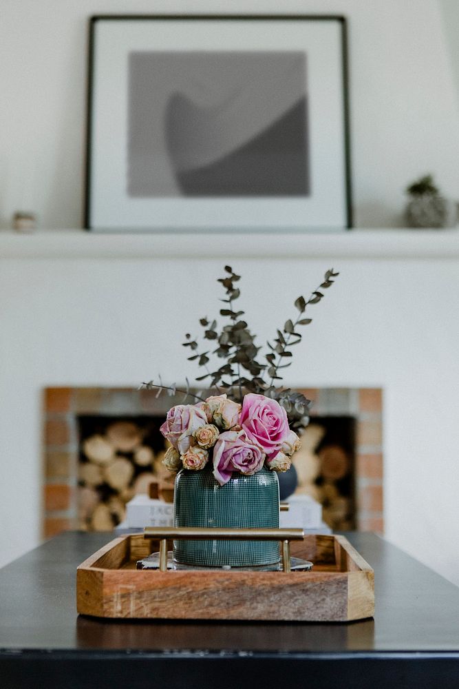 Flowers on a table by the firewood