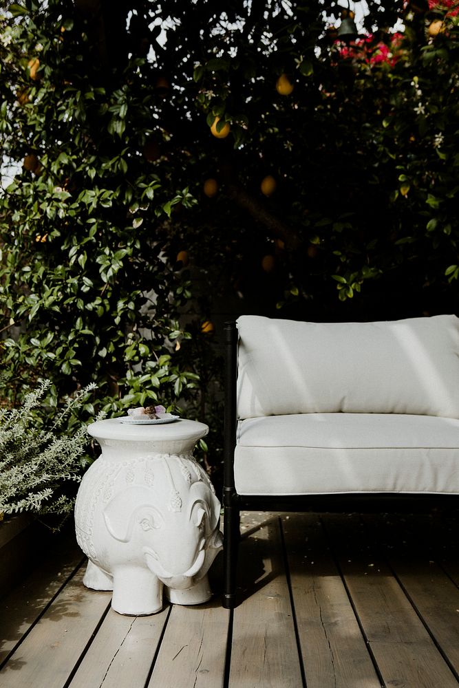 Outdoor wooden couch with white cushions