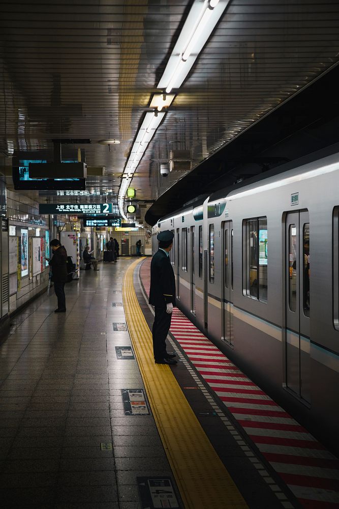 Japanese train conductor at a platform