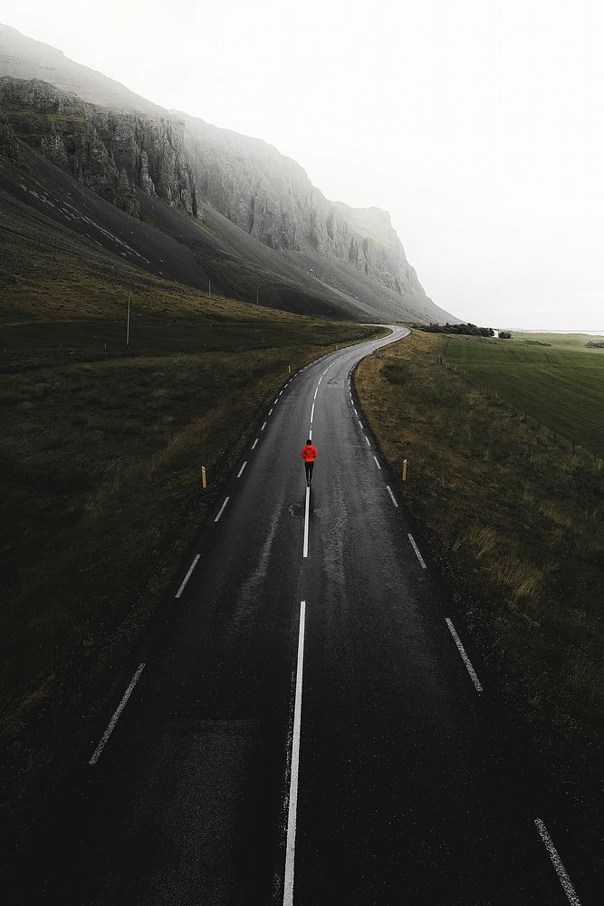 Man walking on a road in Iceland