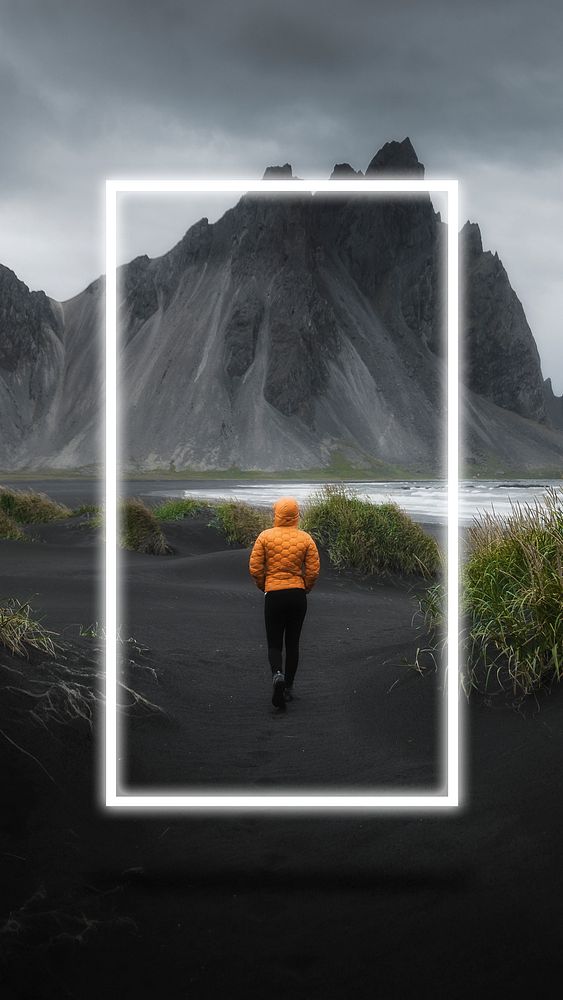Man walking on a black sand beach, Iceland mobile phone wallpaper