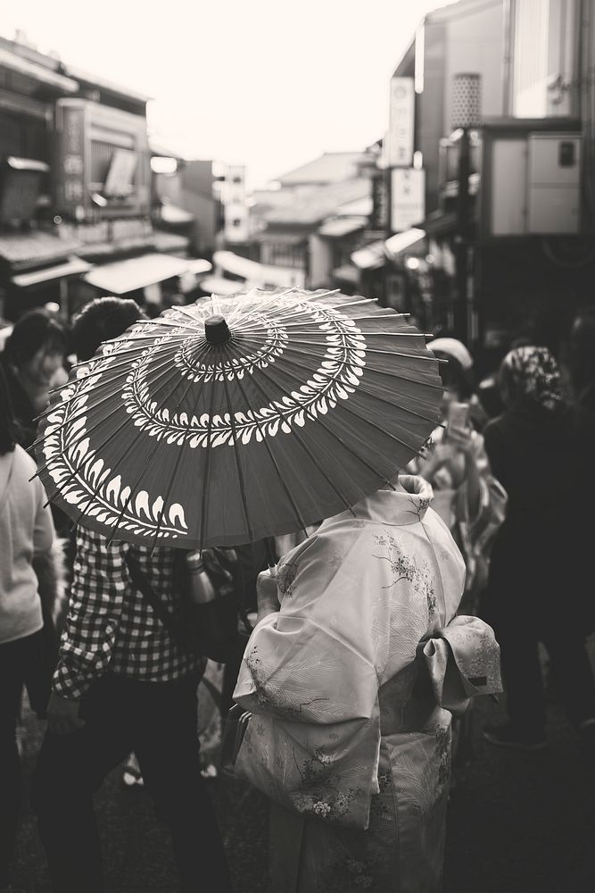 Woman in yukata walking on a crowded street