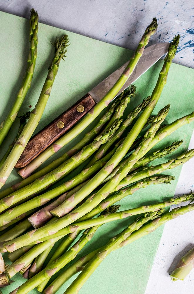 Fresh asparagus on a green cutting board