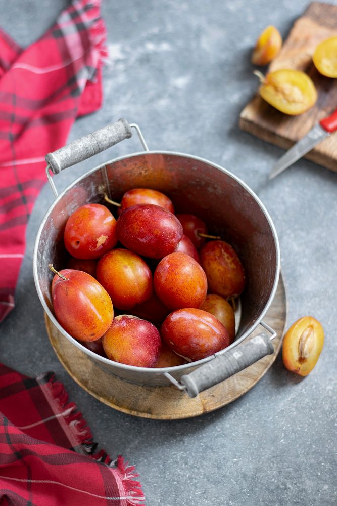 Fresh ripe plums in a pot