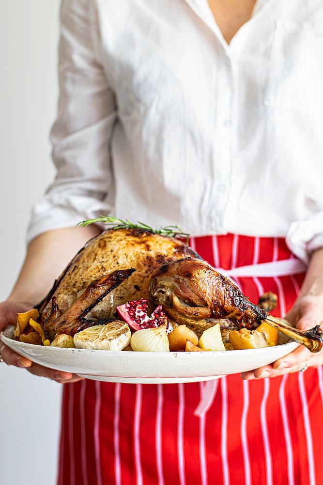 Woman preparing for roasted turkey for thanksgiving