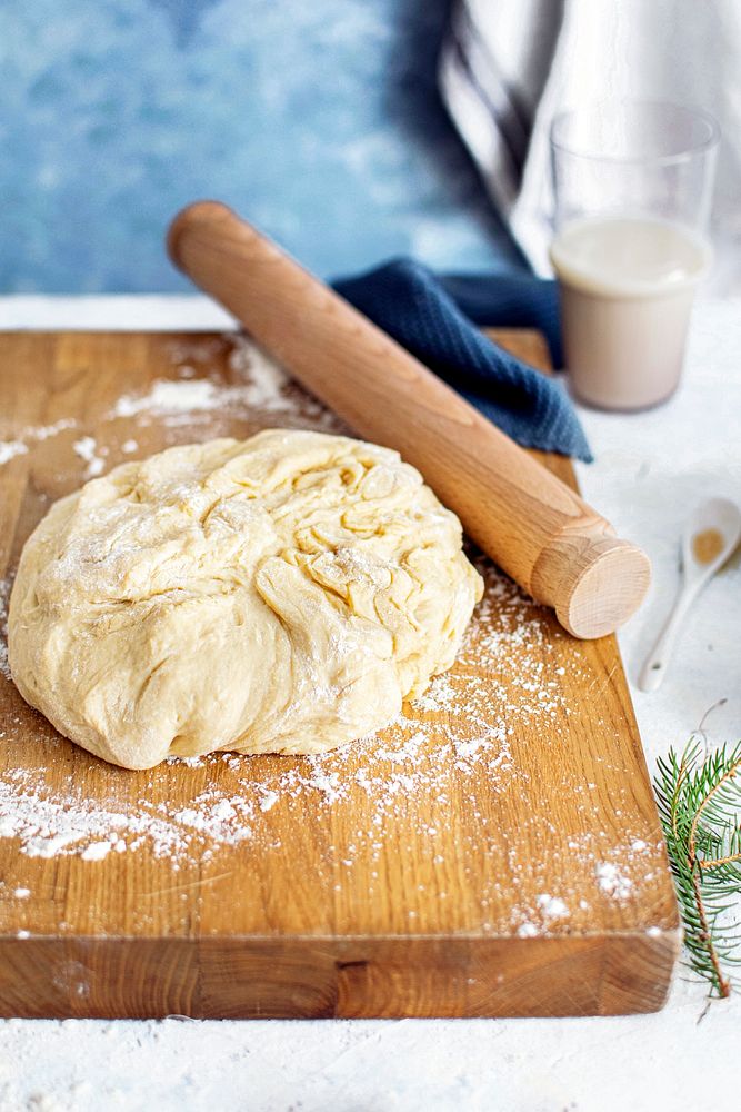 Fresh dough by a rolling pin