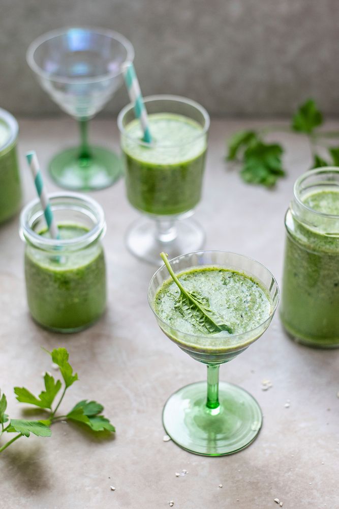 Green smoothie decorated with a spinach leaf  in a glass