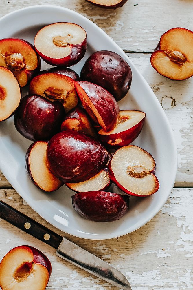 Sliced organic plums in a bowl