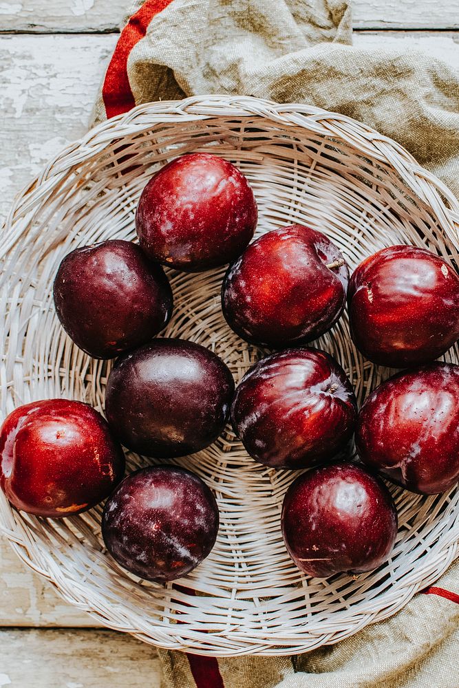 Oragnic plums in a basket