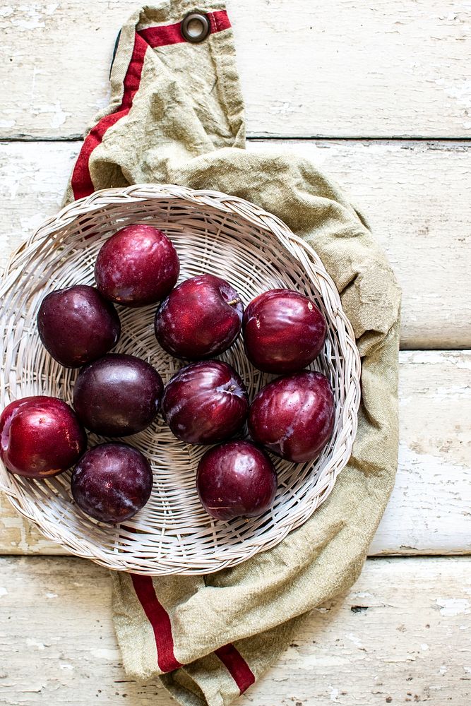 Oragnic plums in a basket