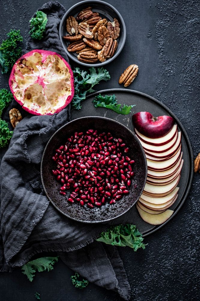 Closeup of fresh pomegranate with sliced apple food photography