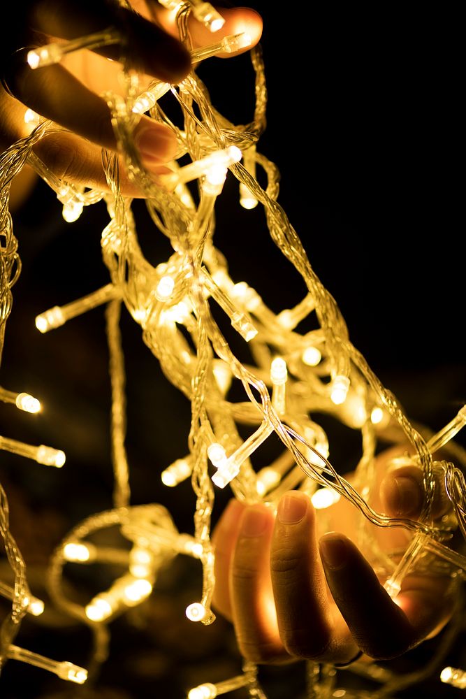 Hands holding garland decoration lights