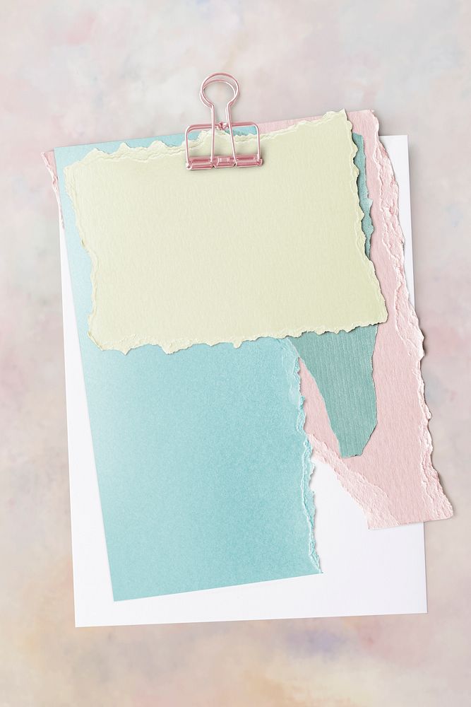 Blank torn pastel paper templates set with a paperclip