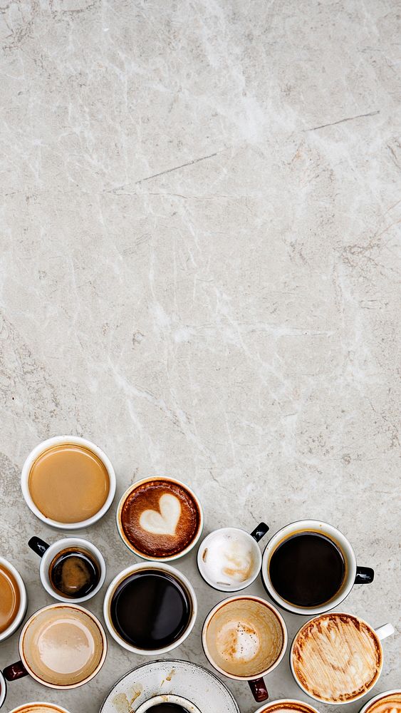 Assorted coffee cups on a marble textured background