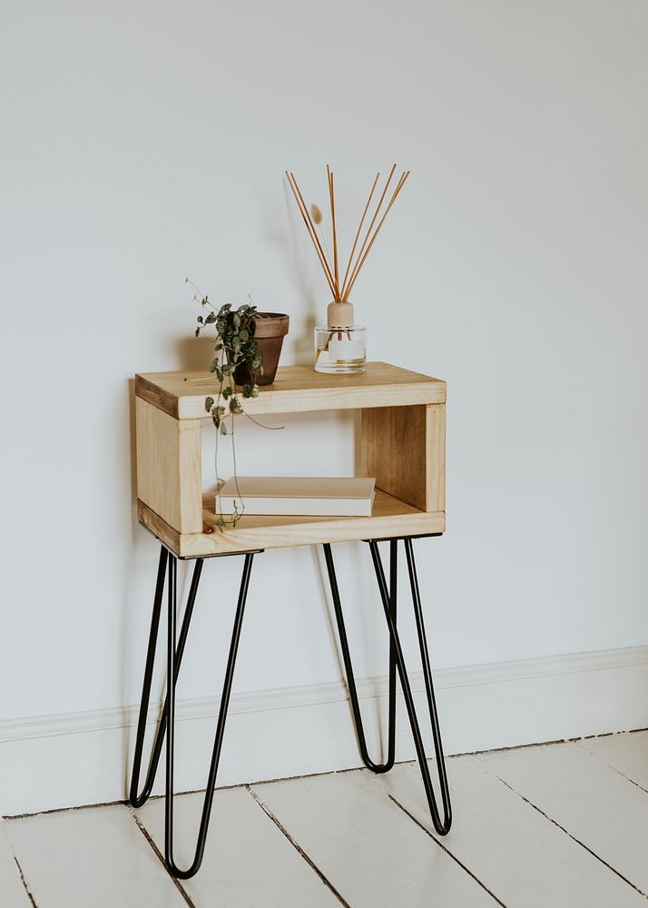 Bedside table with room diffuser and plant