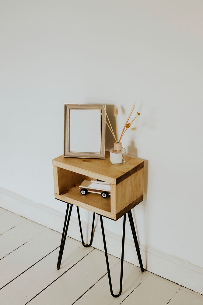 Empty wooden frame, bedside table in kids playroom, home decor