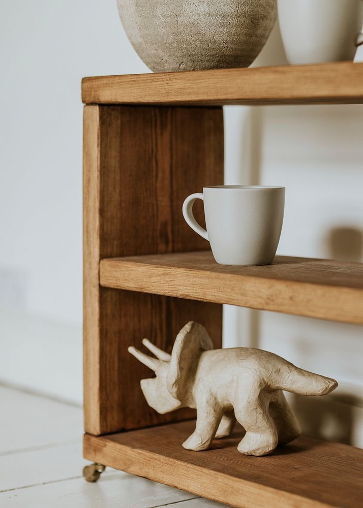 Handmade cup on wooden shelf, home decor