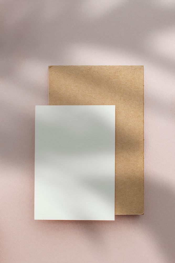 Blank postcard with envelop on a pink background