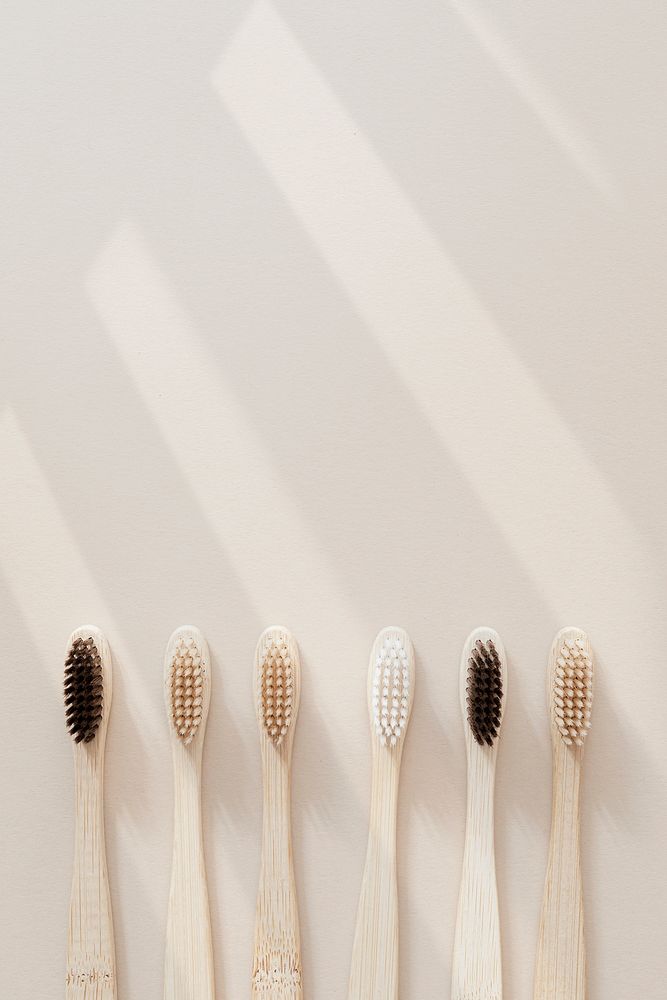 Natural wooden toothbrushes on beige background