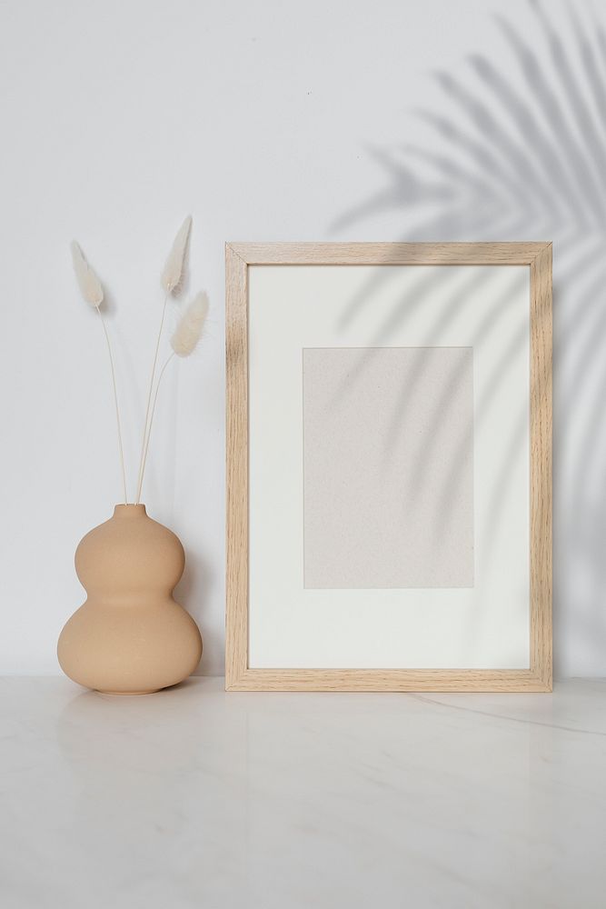 Empty wooden frame with dried flowers in a gourd vase mockup