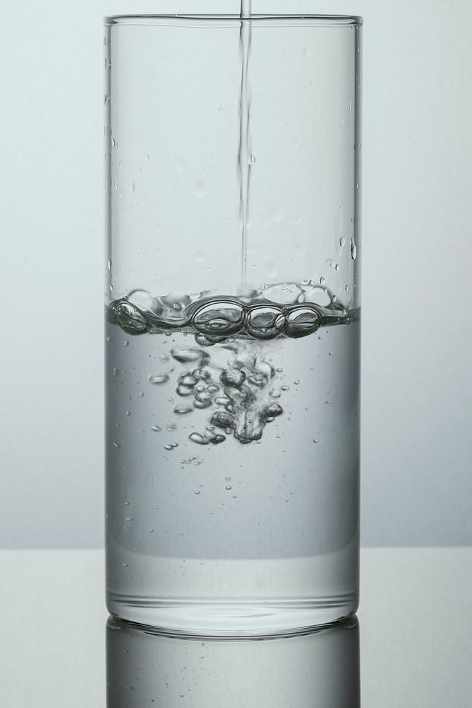Macro shot of pouring water into a glass