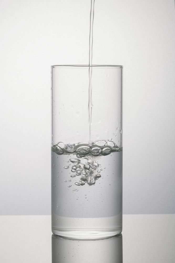 Macro shot of pouring water into a glass