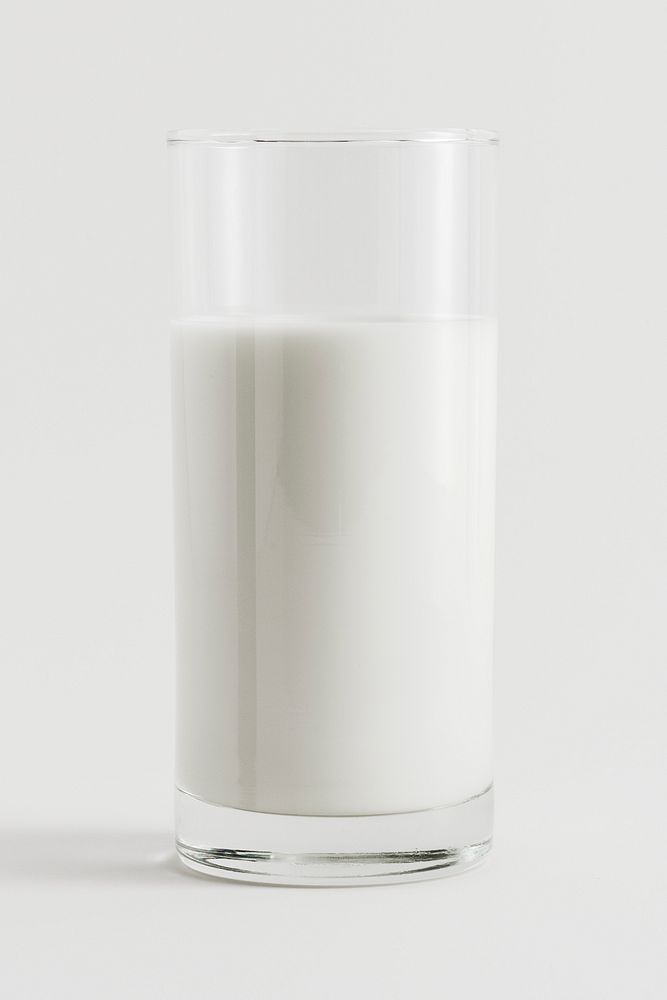 Fresh milk in a glass on white background