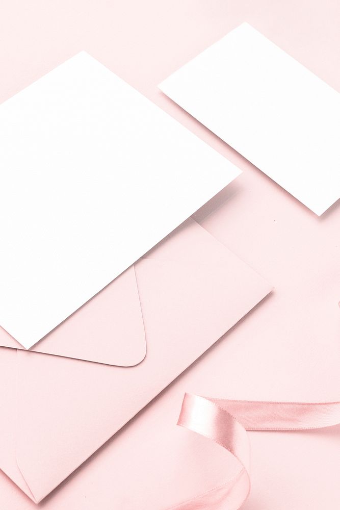 Blank white cards with envelope on pink background