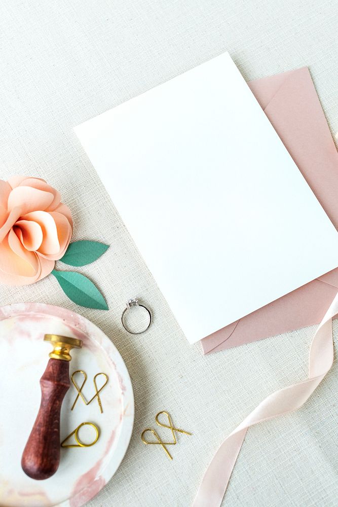 Blank white card with a diamond ring and a pink rose