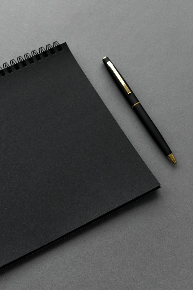 Black notebook with a pen