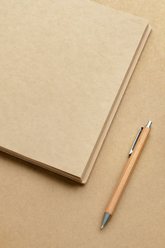 Natural brown paper notebook with a pencil