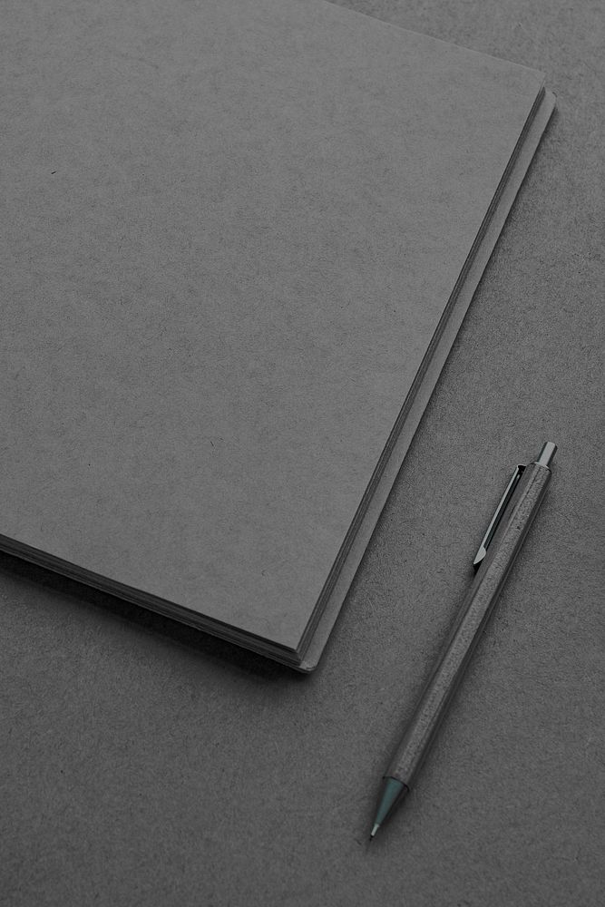 Blank plain black notebook with a pen