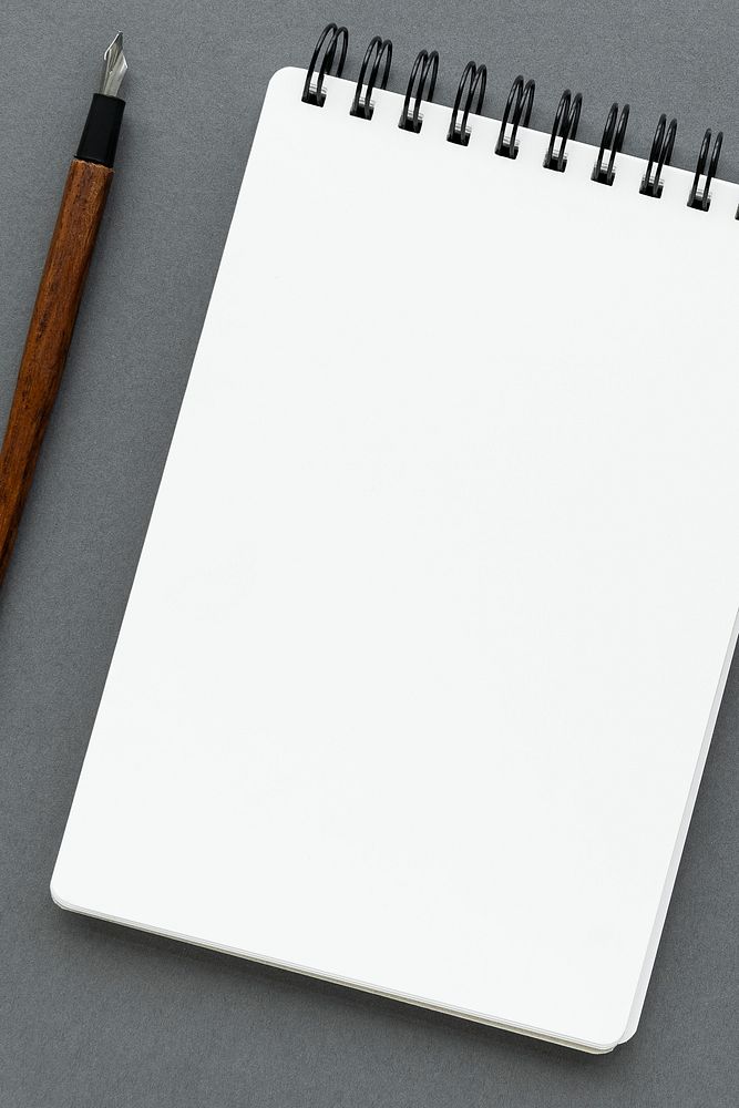 Blank plain white notebook with a fountain