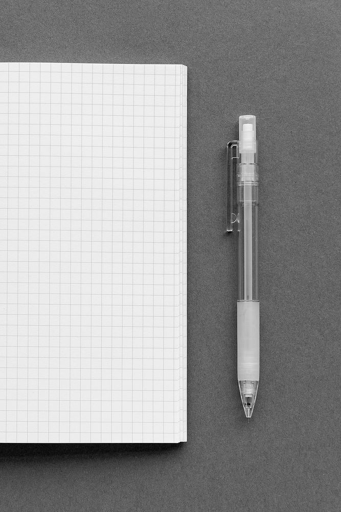 Blank white grid paper notebook with a pencil
