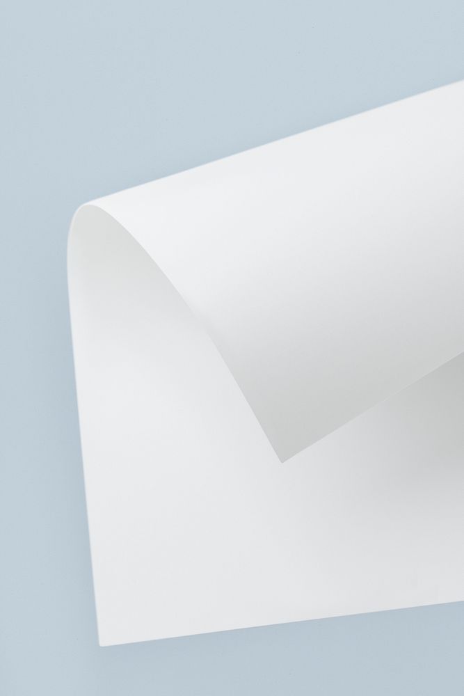 Blank white folded paper mockup on a bluish gray background