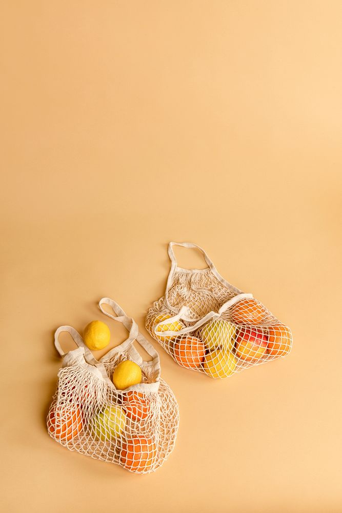 Reusable net bag with fruits on an orange background