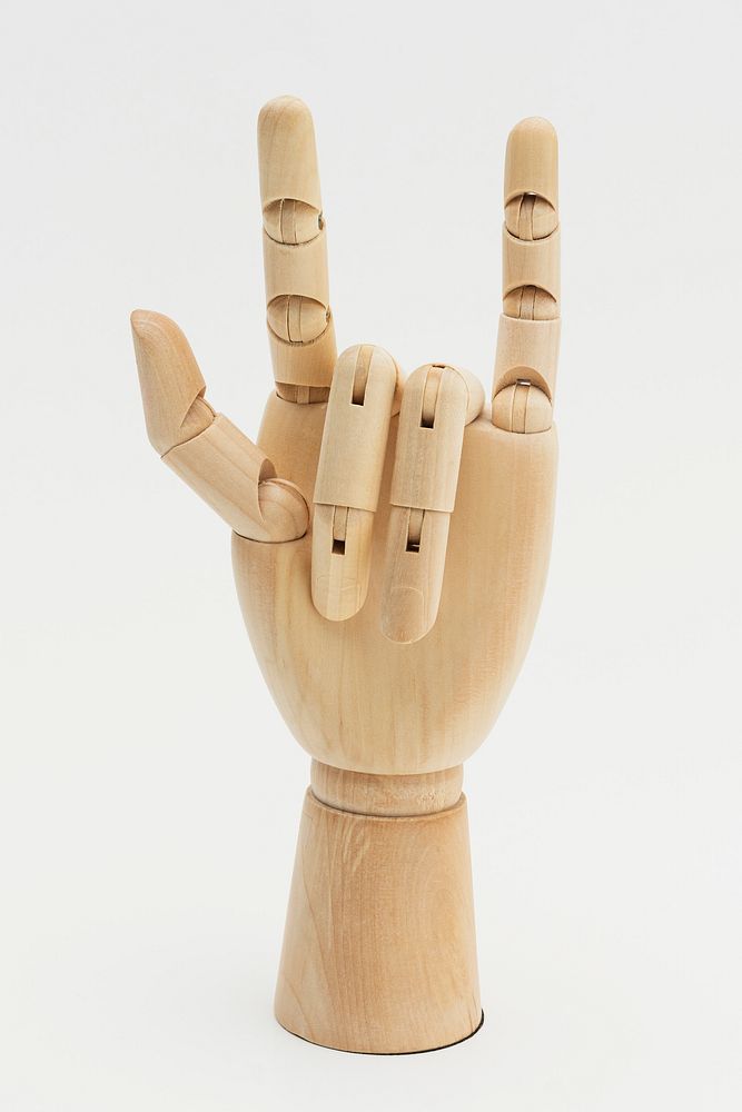 Wooden hand show love symbol on off white background