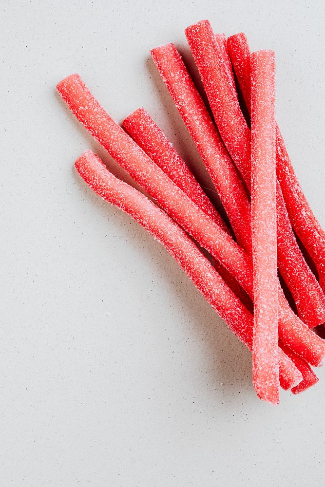 Red chewy candies coated with sugar