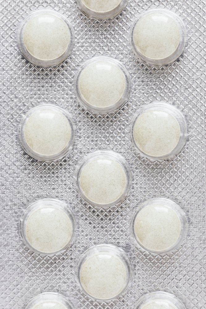 White pills in an aluminum foil blister