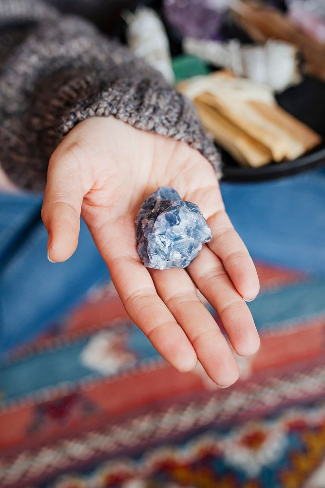 Woman with blue calcite healing crystal 