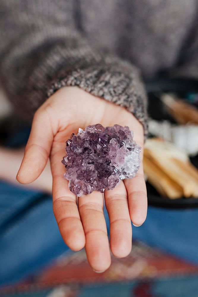 Woman with amethyst healing crystal