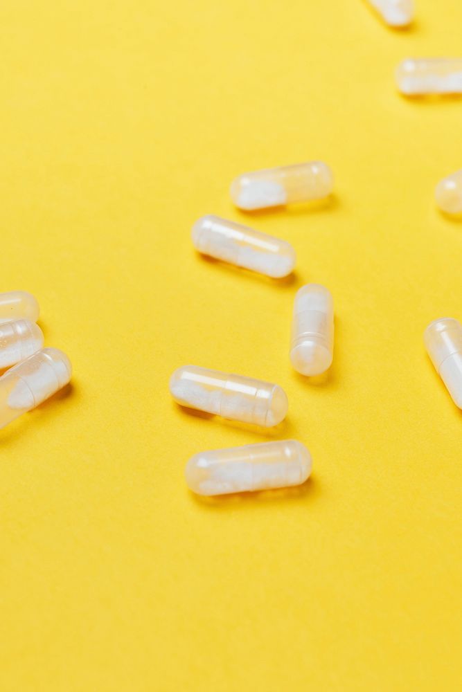 Pills and medication on a yellow background