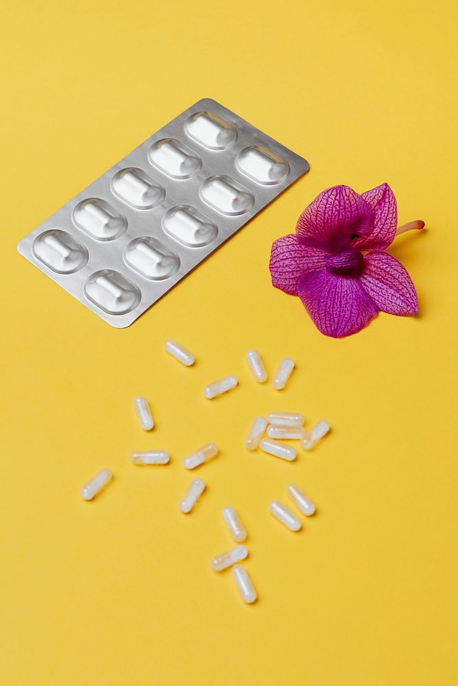 Pills and medication on a yellow background