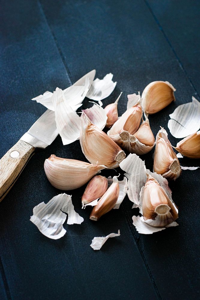 Natural fresh garlic and a knife on a table