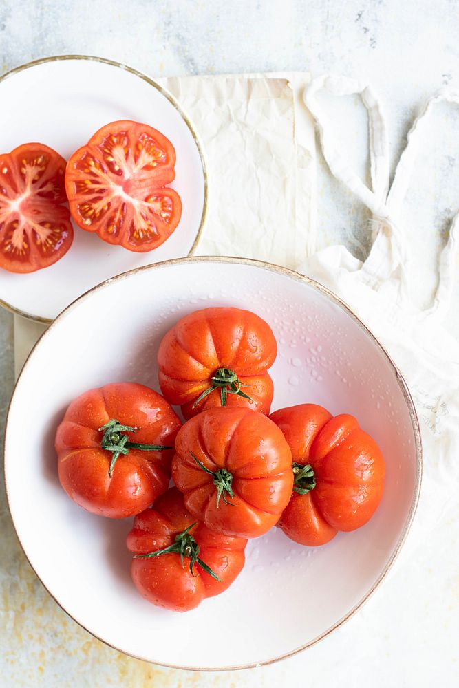 Natural fresh organic tomatoes in white bowl